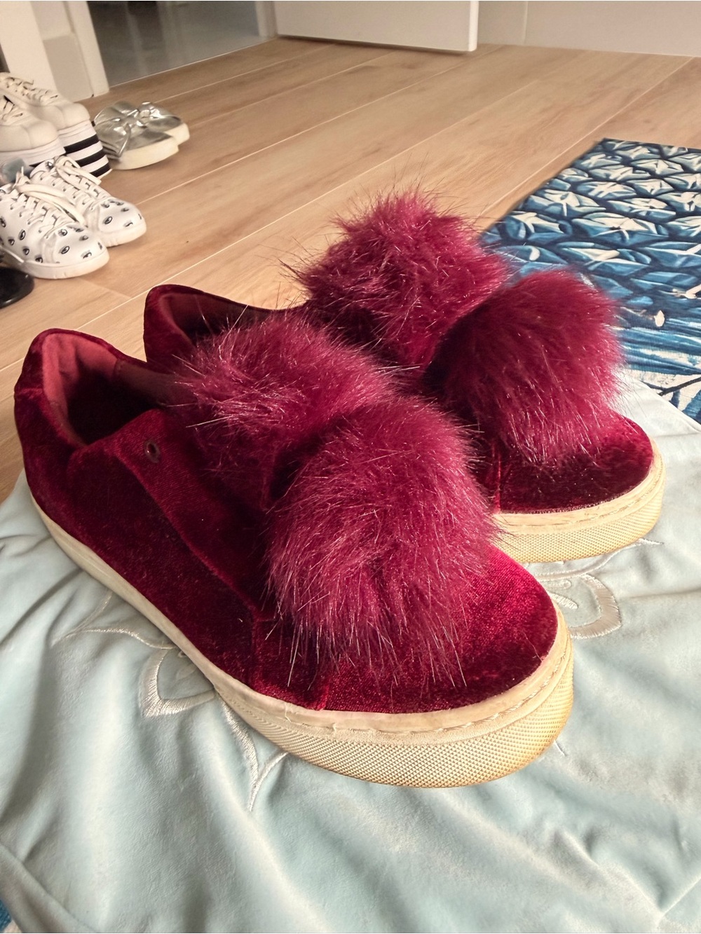 Sam Edelman’s Velvet Pom-Pom Slip-On Sneakers in Burgundy